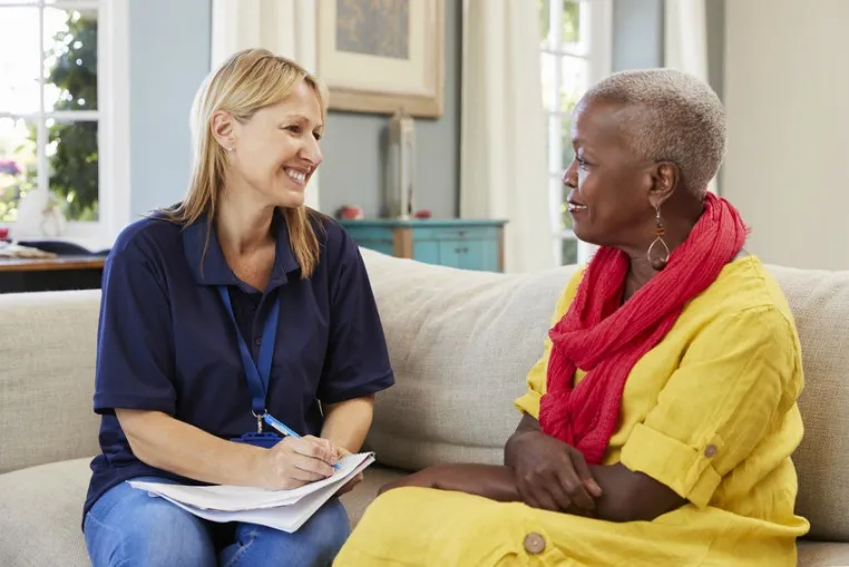 A support worker having an assessment conversation with a service user